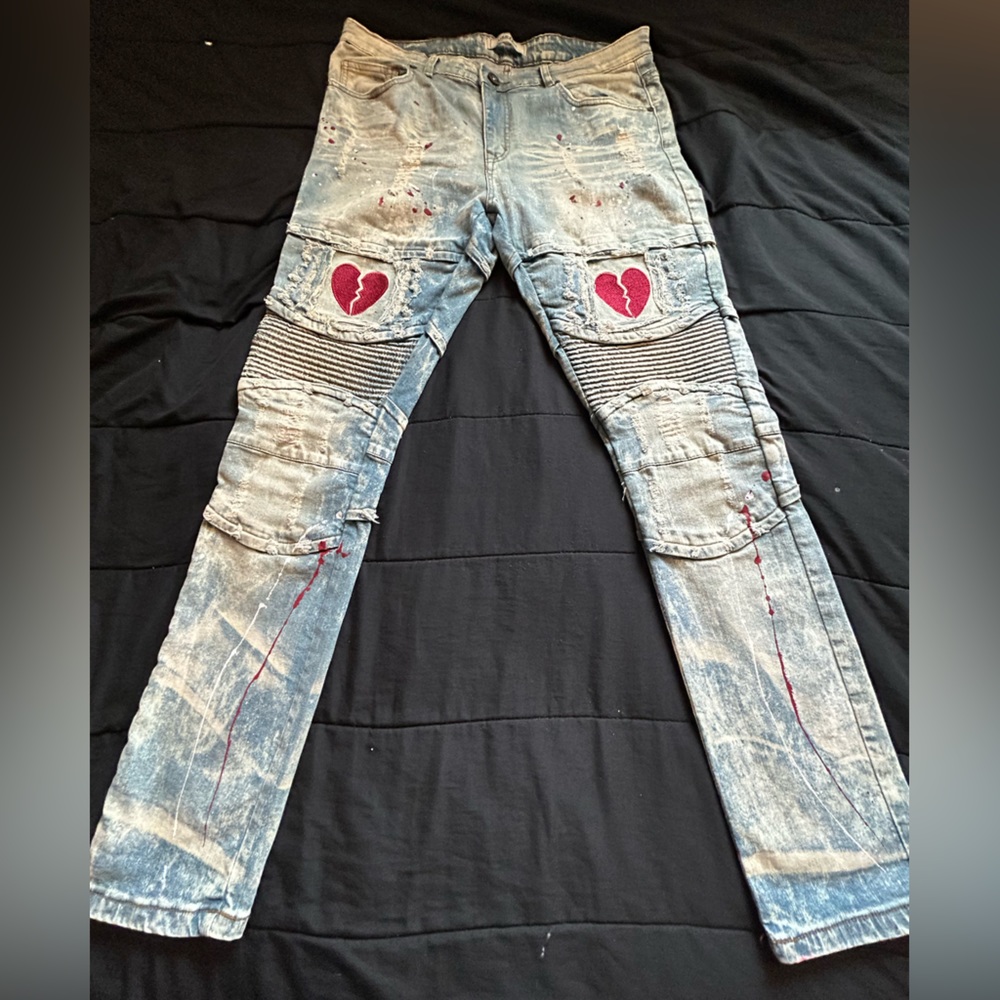 Track 23 "Heartbreaker" design features red splatter distressed beige jeans